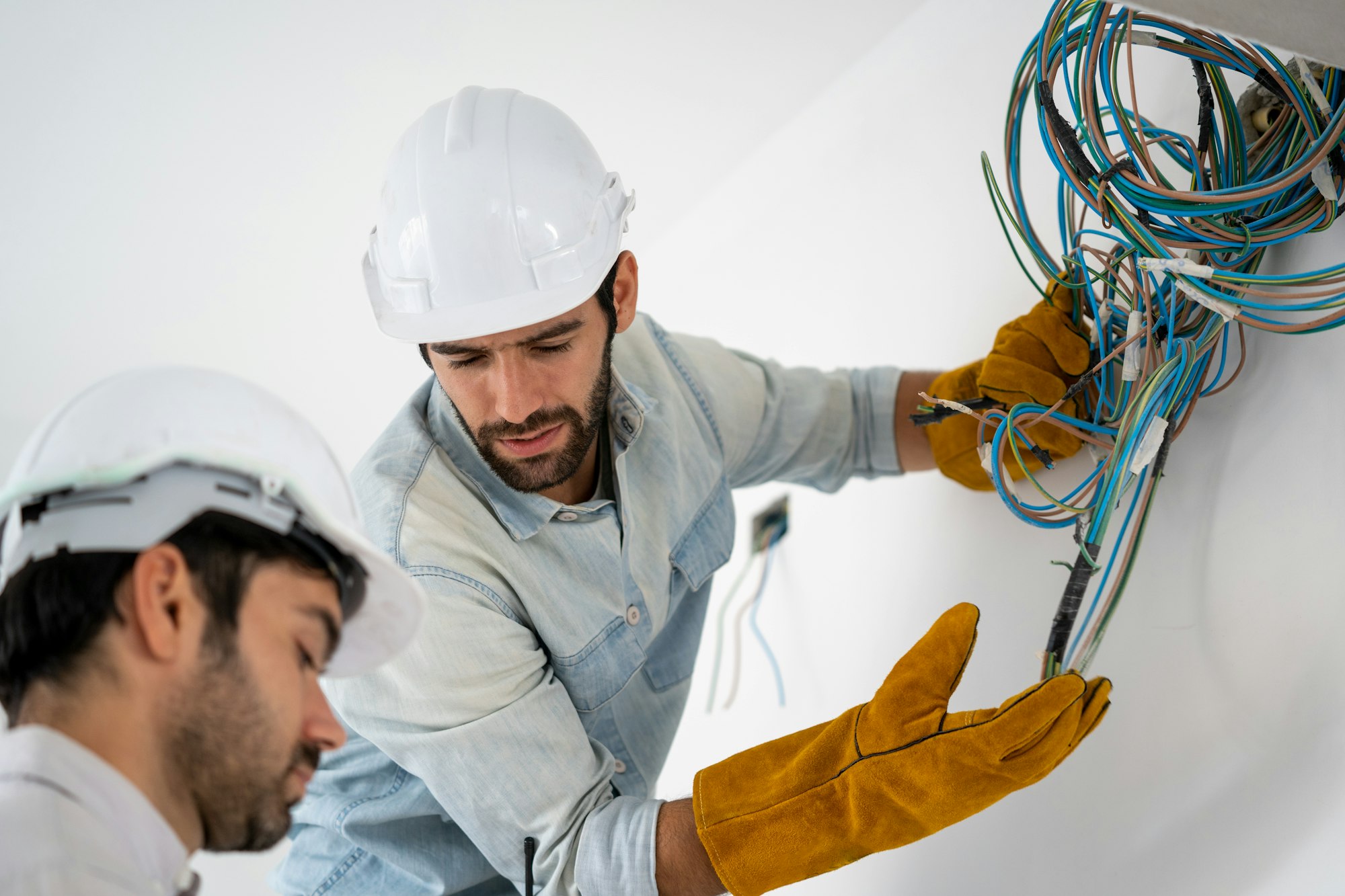 Electrician working with cable on the construction site, House and house reconstruction.